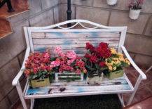 Flowers in square boxes on top of white bench