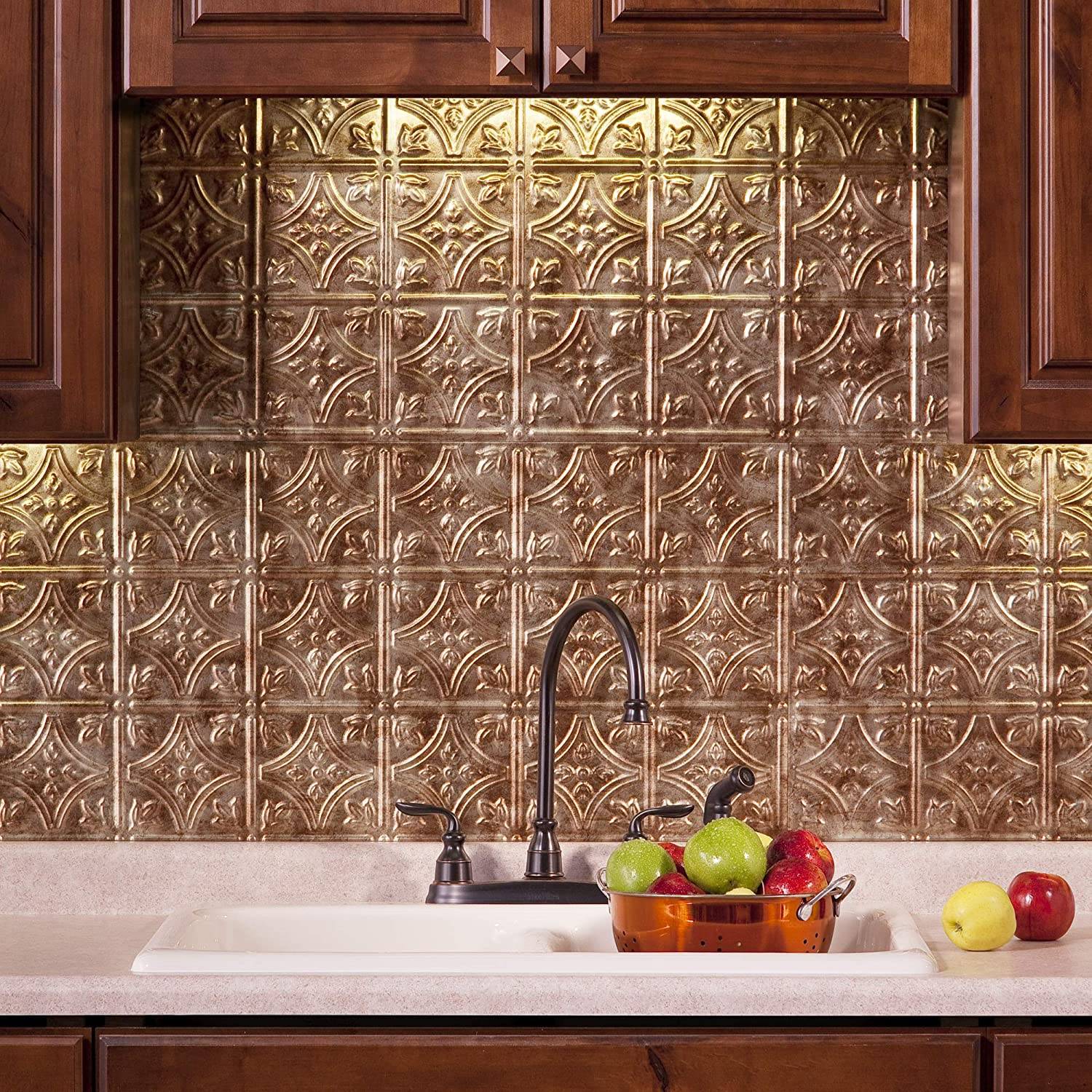 Green and red apples on kitchen sink with black faucet