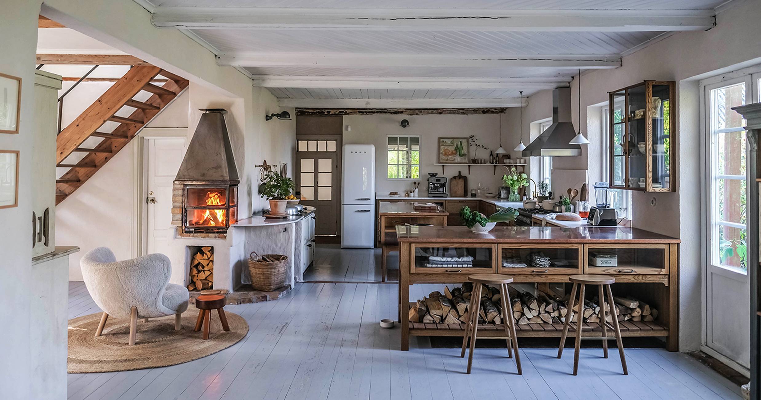 Logs under kitchen counter and metal fire pit