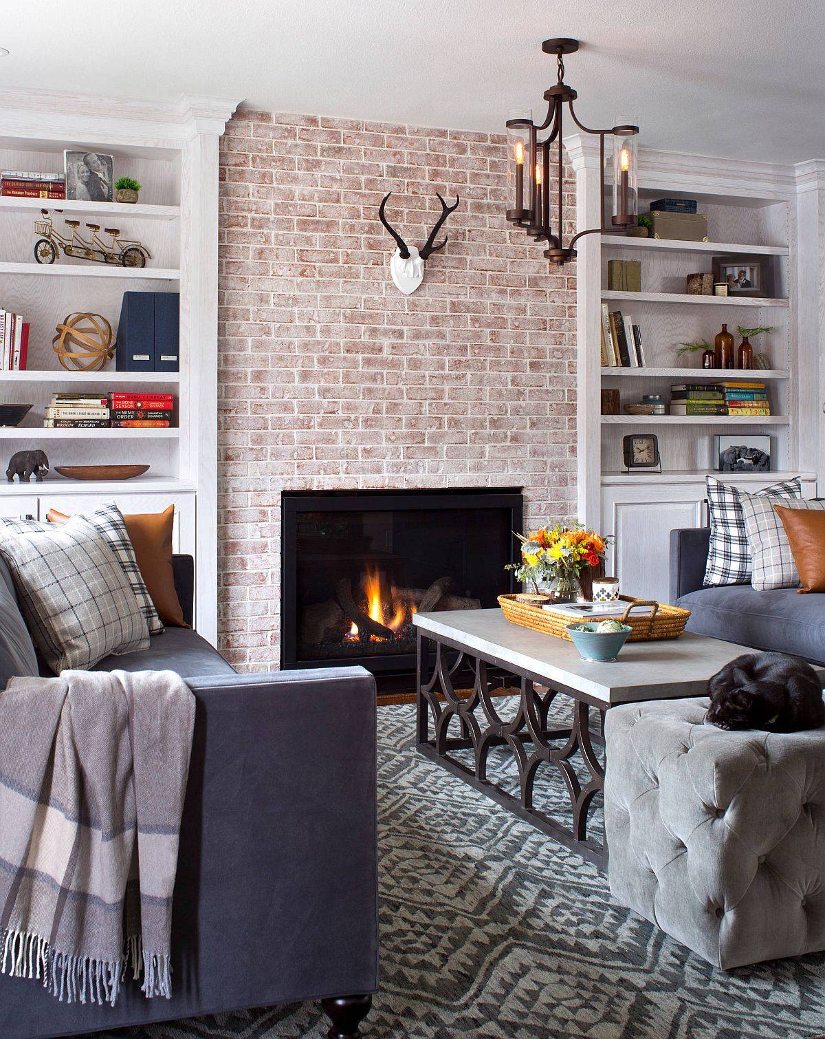 Modern farmhouse style living room with an elegant brick section and fireplace