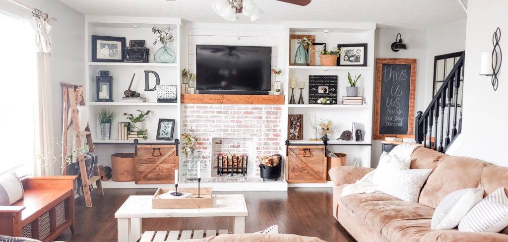 brick faux fireplace with wooden mantel