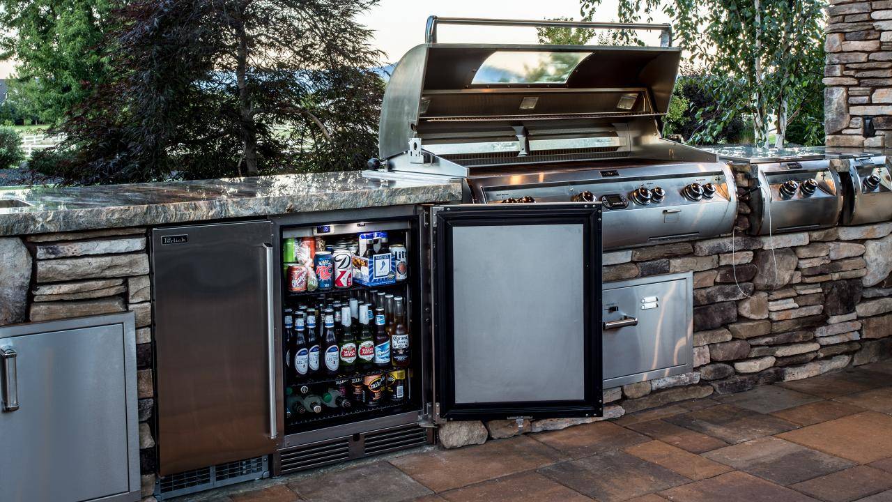 small outdoor kitchen with fridge