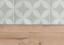 Patterned-tile-floor-of-the-kitchen-next-to-the-wooden-floor-of-the-living-room-10612-217x155