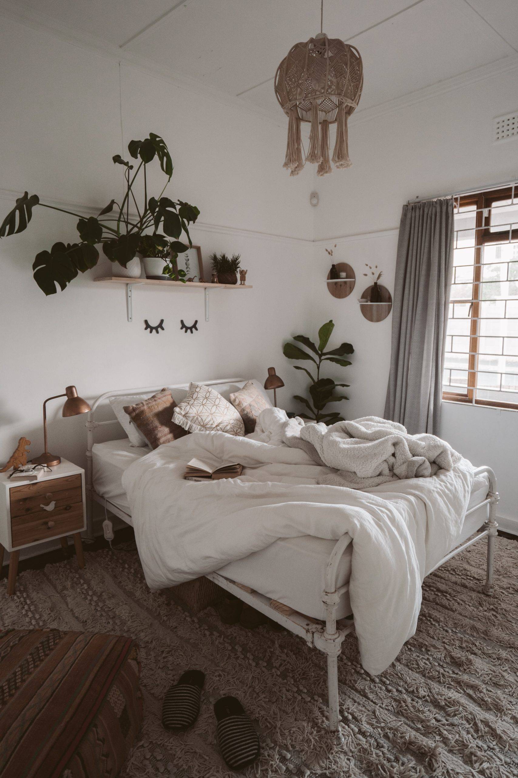 Plants above an unkept bed | 41 Charming Farmhouse Bedroom Ideas for ...