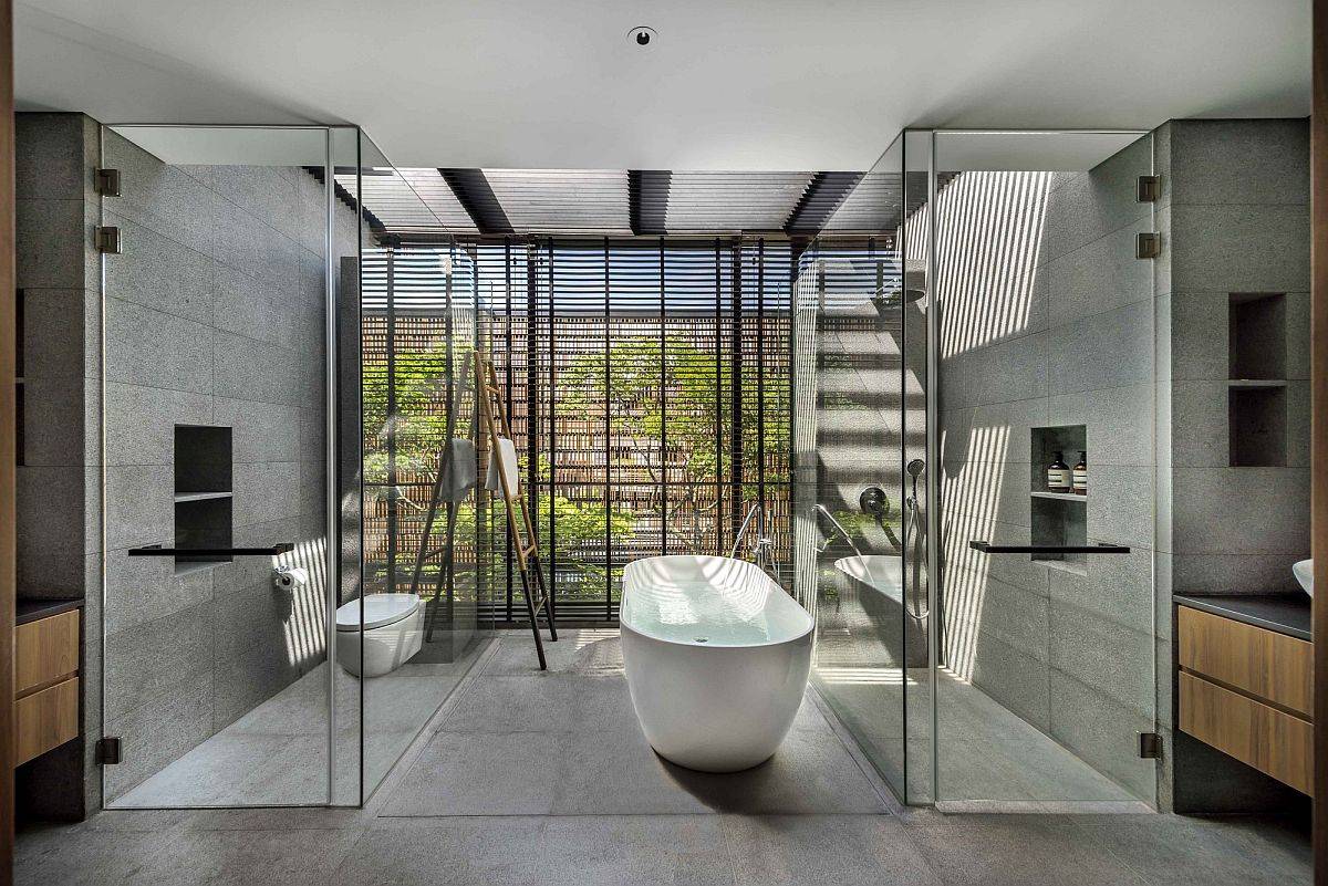 Polished contemporary bathroom in gray with glass walls and a fabulous white bathtub