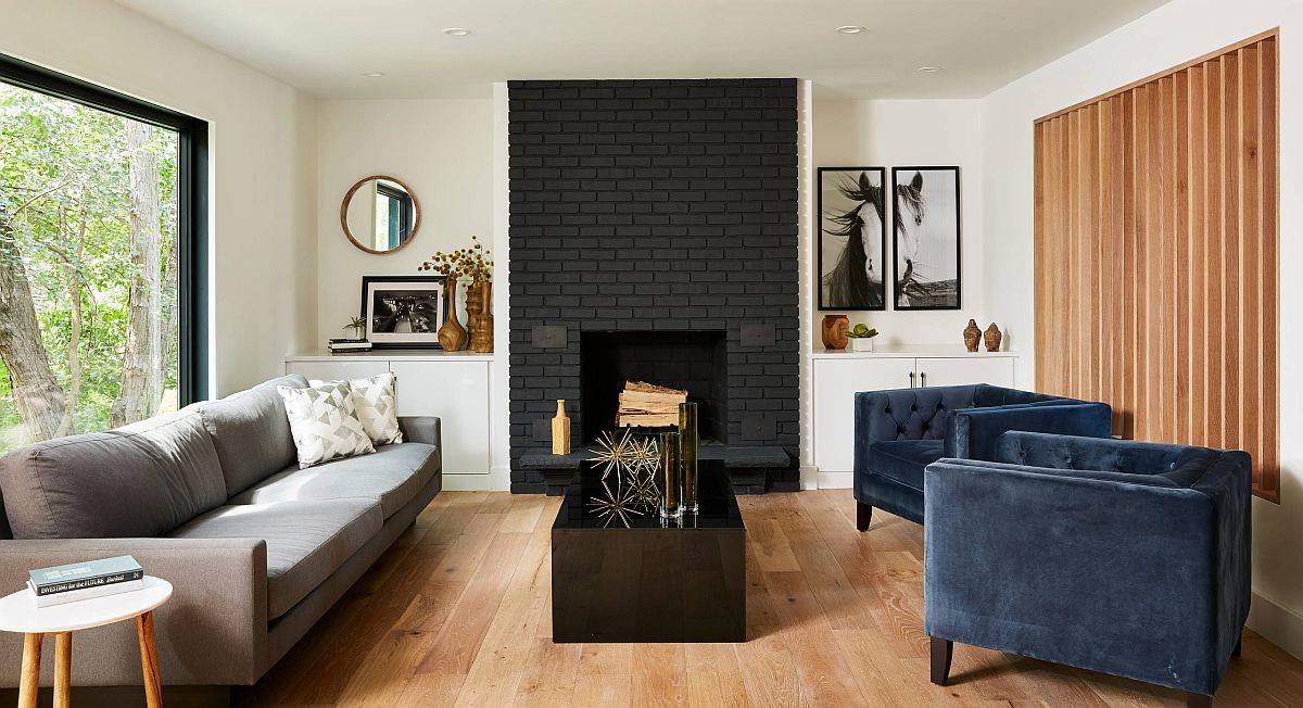 Polished contemporary living room with dark, painted brick fireplace