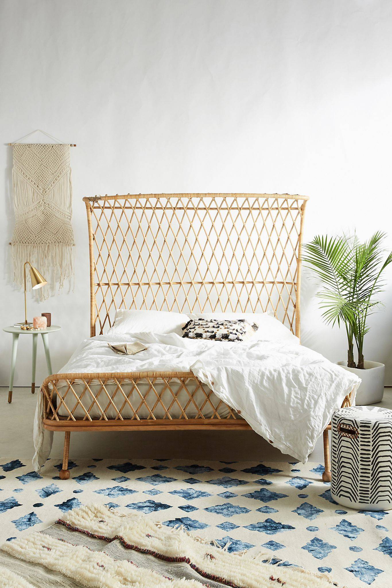 Rattan bed with potted plant on the side