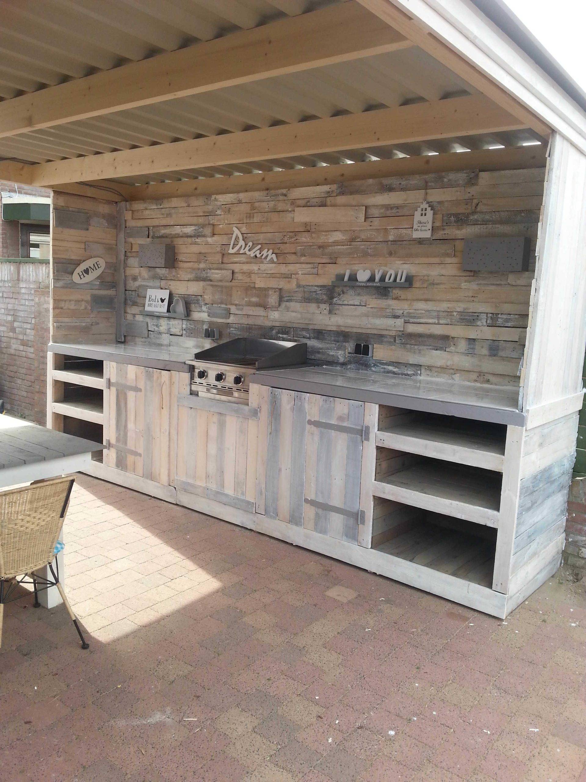 Rustic Outdoor Kitchen with Stone Backdrop