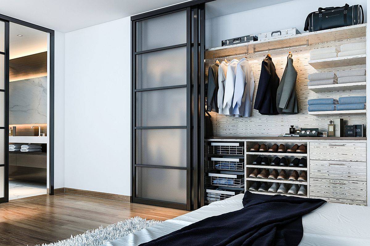 Sliding frosted glass doors used for the small men's closet in the contemporary bedroom