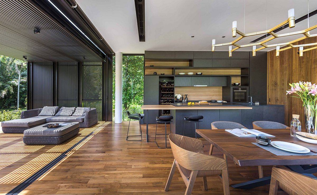 Sliding glass doors open up the new living area towards the deck and the green outdoors