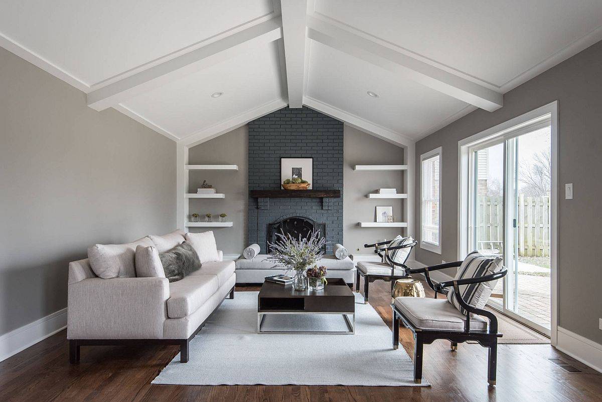 Spacious, double-height living room in gray with gray, painted fireplace