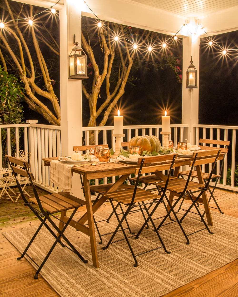 Table with pumpkin and two candles