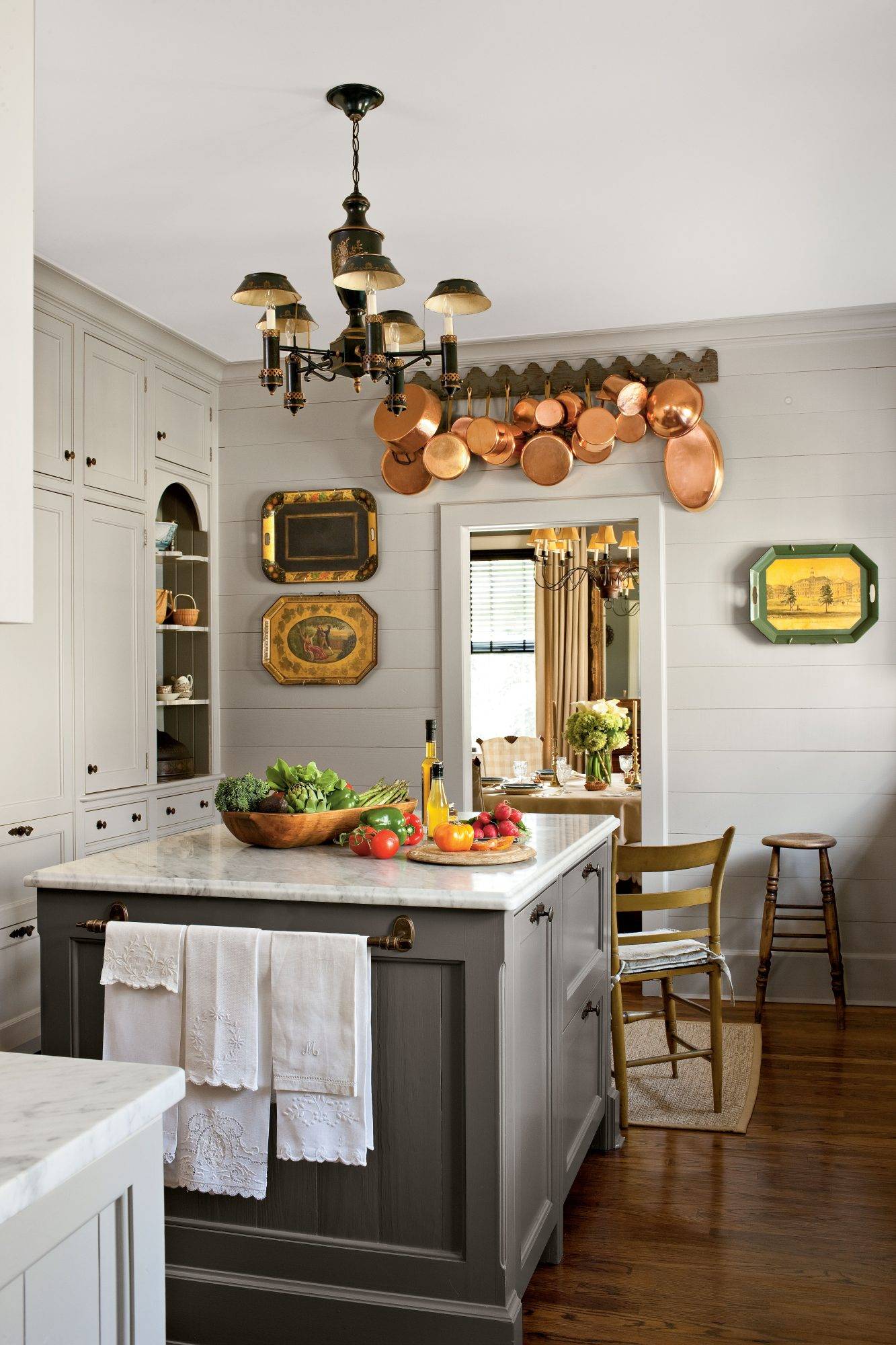 Vintage platters and cookware hanging on white wall