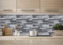 Vinyl decorative tiles in different grey hues in kitchen wall