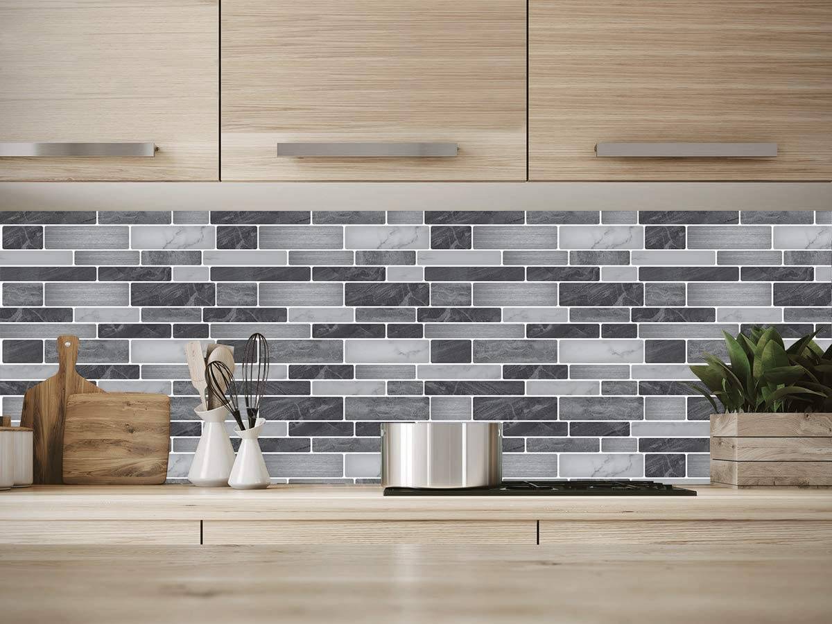 Vinyl decorative tiles in different grey hues in kitchen wall