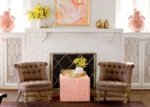 brown armchairs in front of white painted brick fireplace