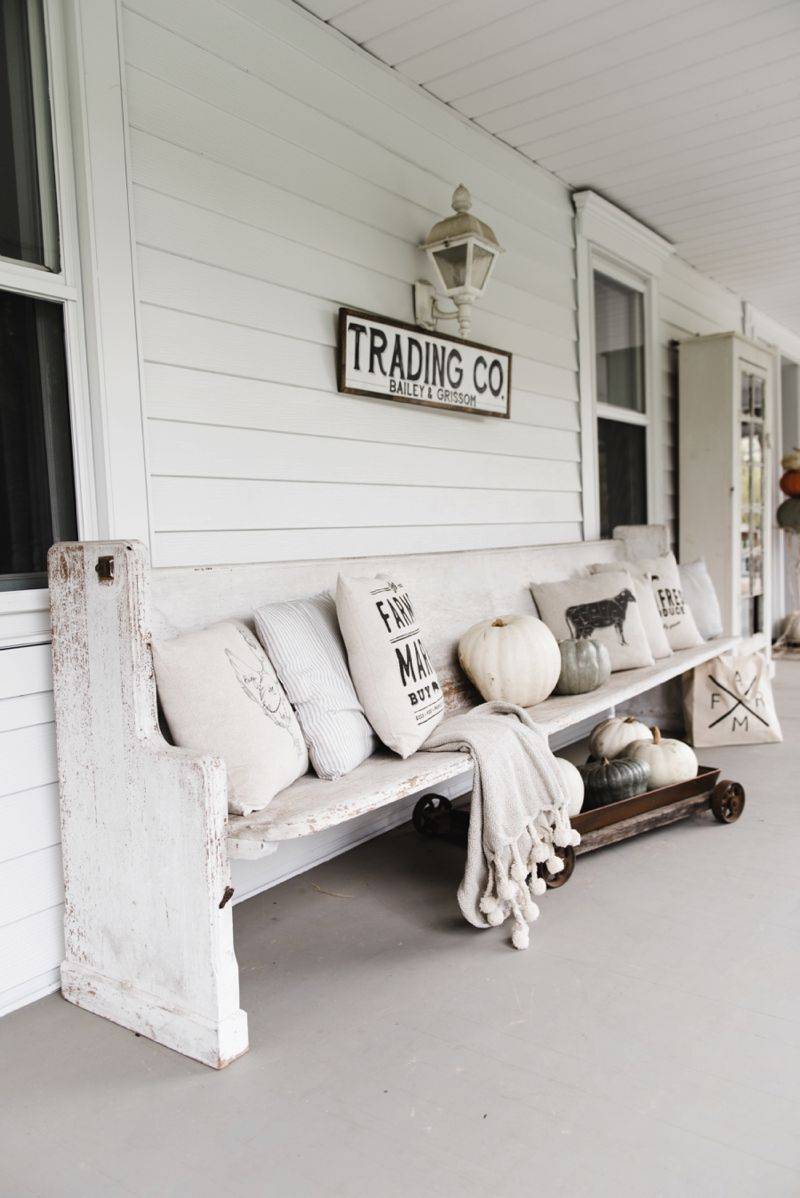 Antique Wooden Bench with Earth Toned Pillows