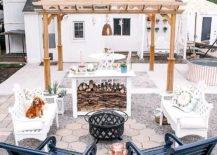 Backyard with pergola and white tables and chairs