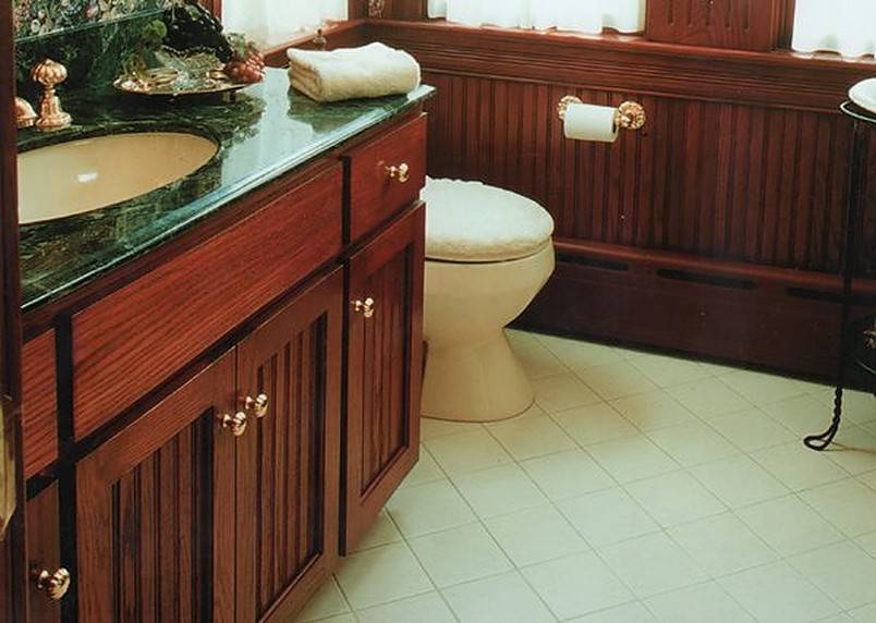 Bathroom sink in dark green and brown cabinetry