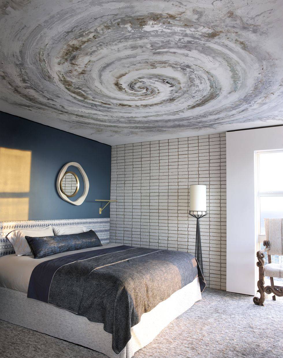 Bedroom with spiral painting on the ceiling