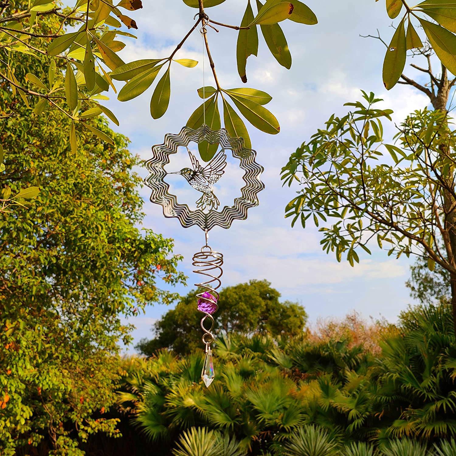 Bird wind spinner hanging from a tree branch