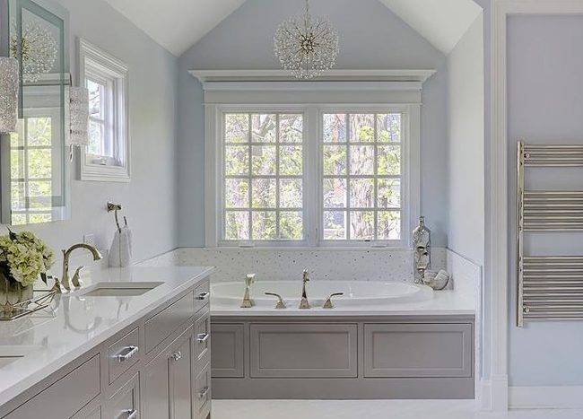 Blue and gray master bath color with round chandelier
