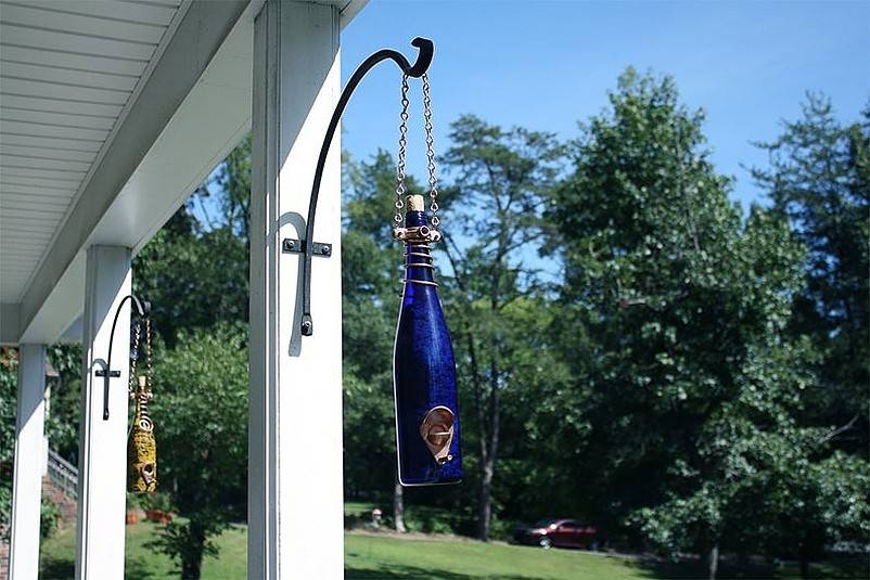 Bottles hanging from house pillars