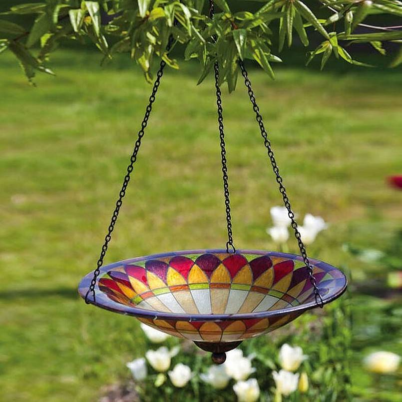 Colorful bird bath hanging from a tree