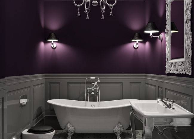 Elegant bathroom with chandelier and purple wall with grey wainscoting