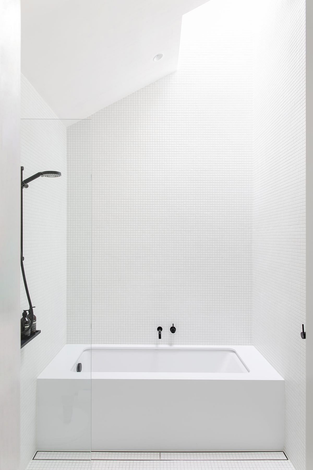 Exquisite contemporary monochromaic bathroom in white with natural light