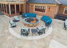 Fire pit surrounded by blue chairs and sofas