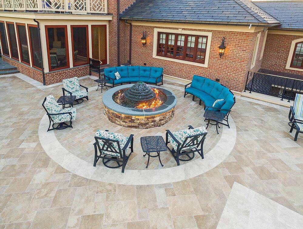 Fire pit surrounded by blue chairs and sofas