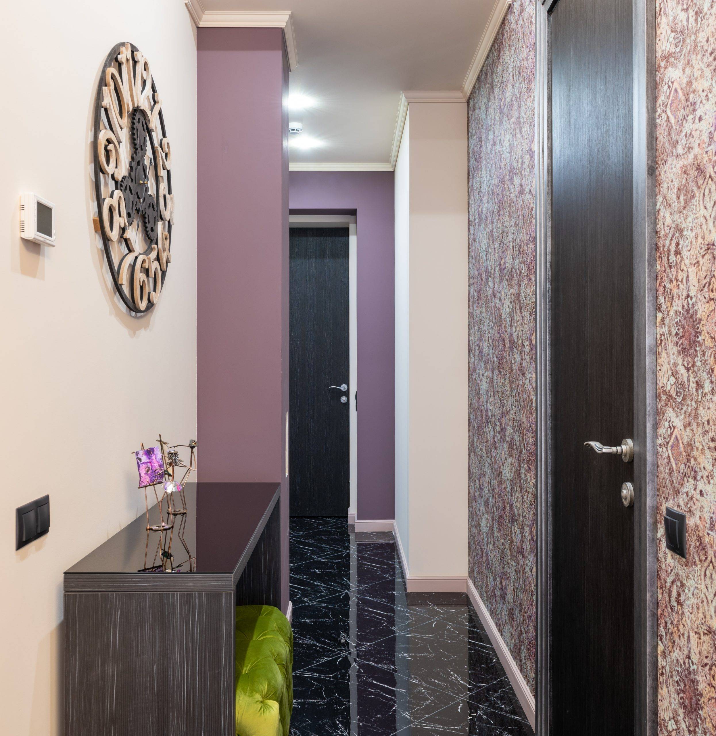 Hallway with lavender walls and huge round clock