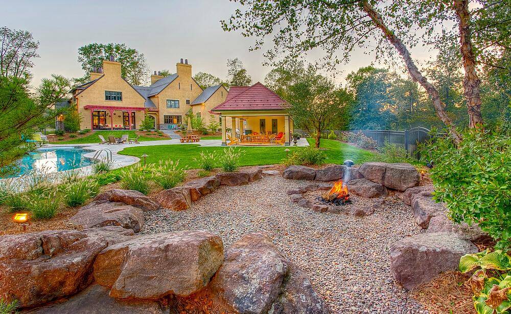 House exterior with pool and fire pit