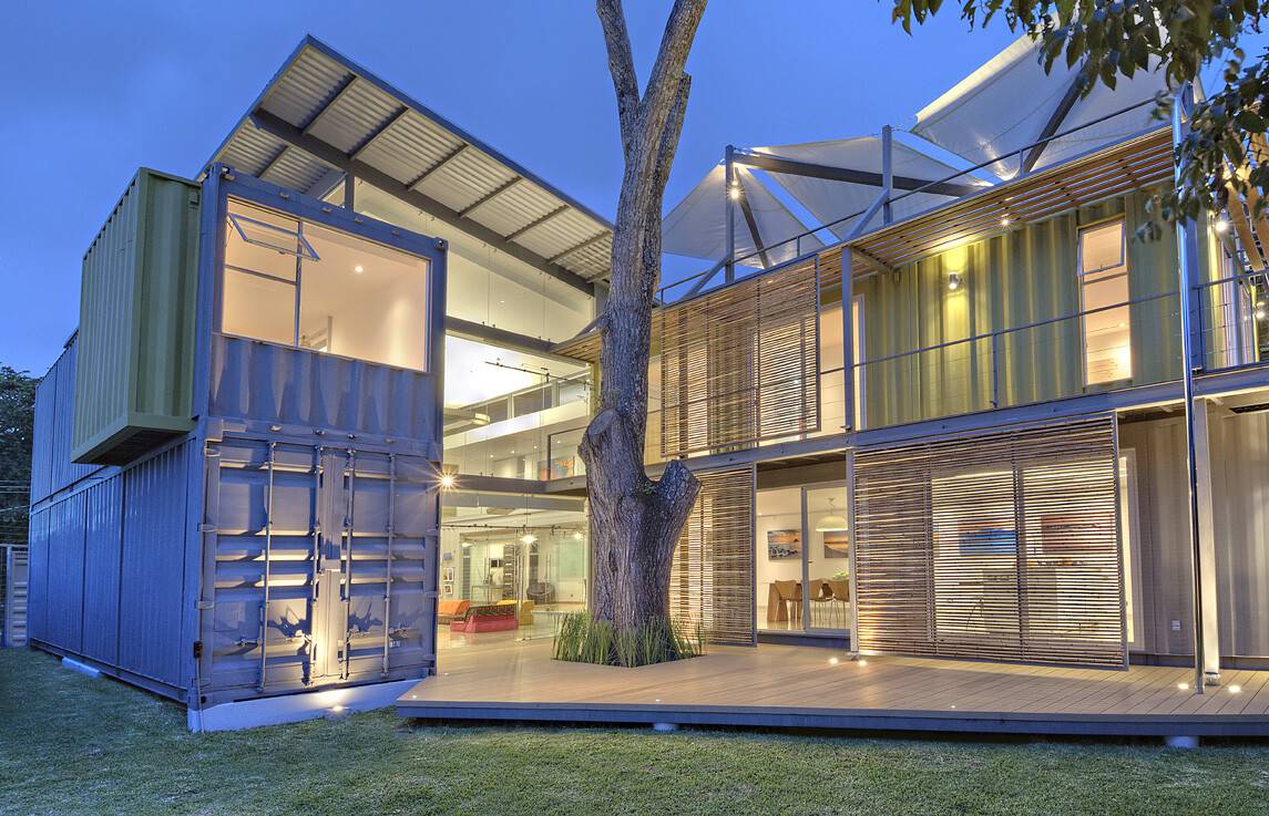 Huge tree in the middle of a container house balcony