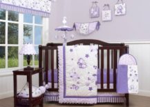 Lavender nursery room with dark brown crib and side table