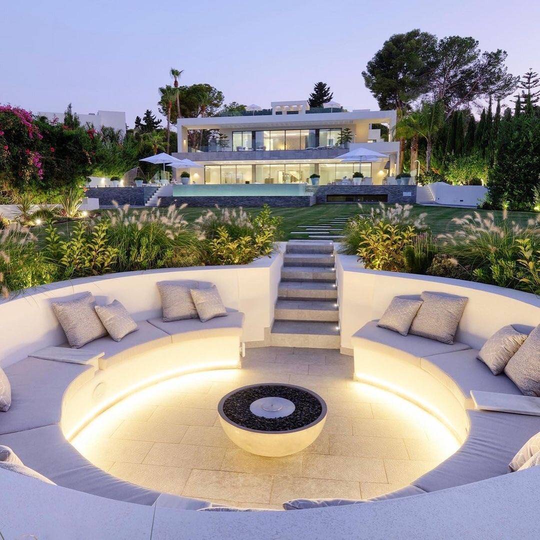 Modern fire pit outside house