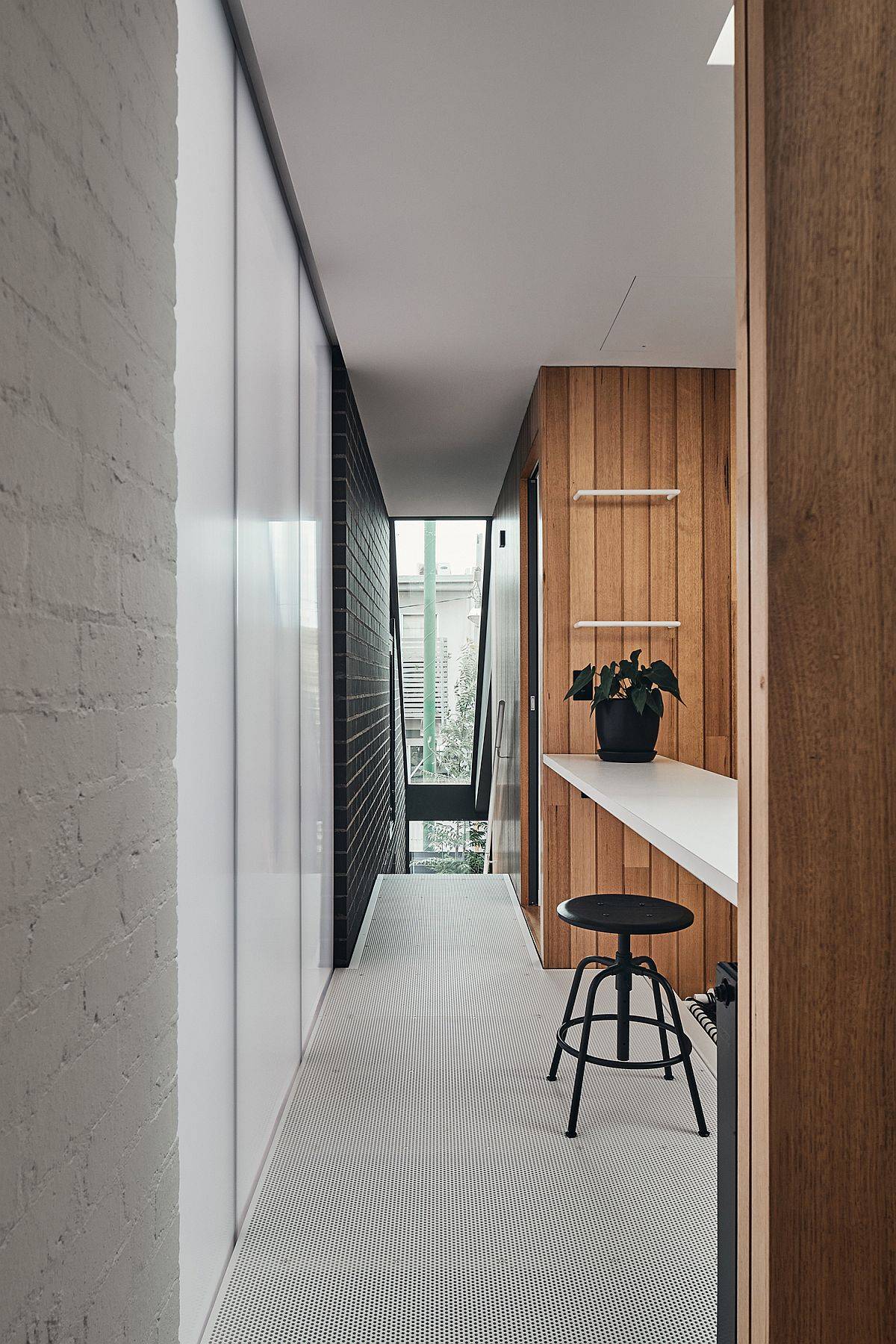 Painted brick walls, polycarbonate panels and woodsy finishes combined inside the smart Aussie home