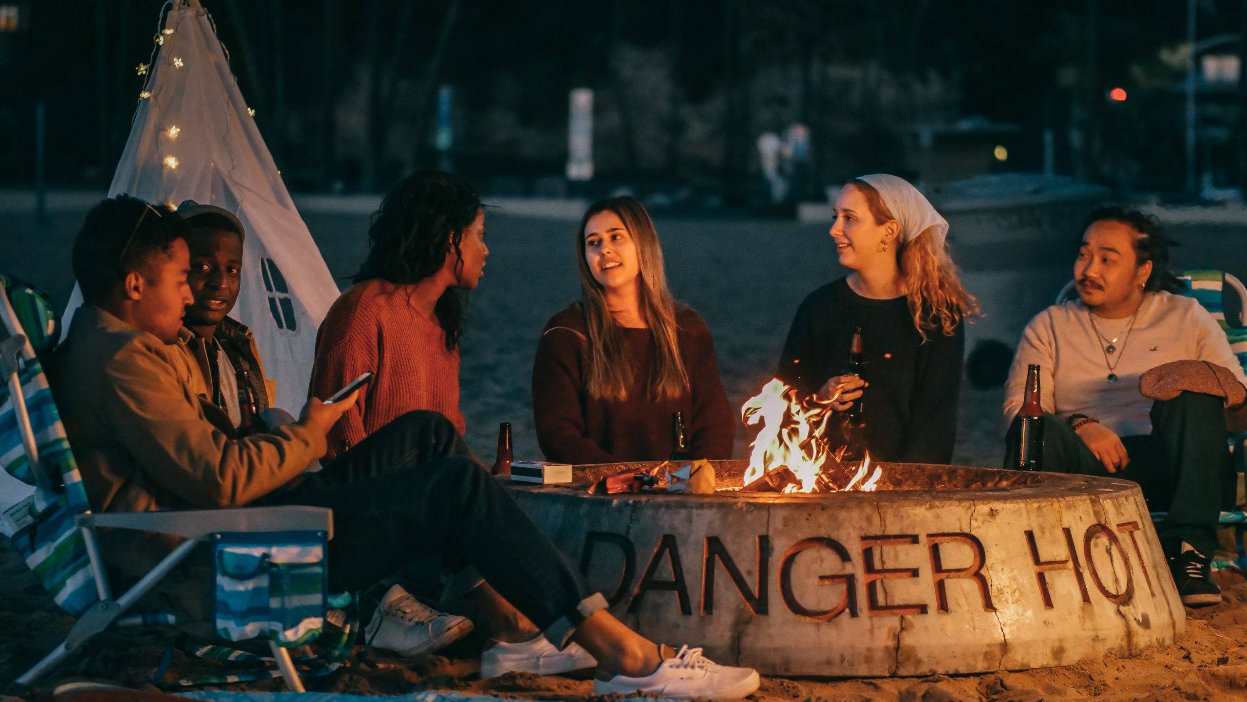 People sitting around fire pit