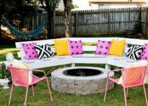 Pink and yellow cushions on long outdoor bench