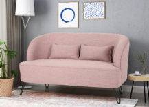 Pink sofa beside tall white lampshade