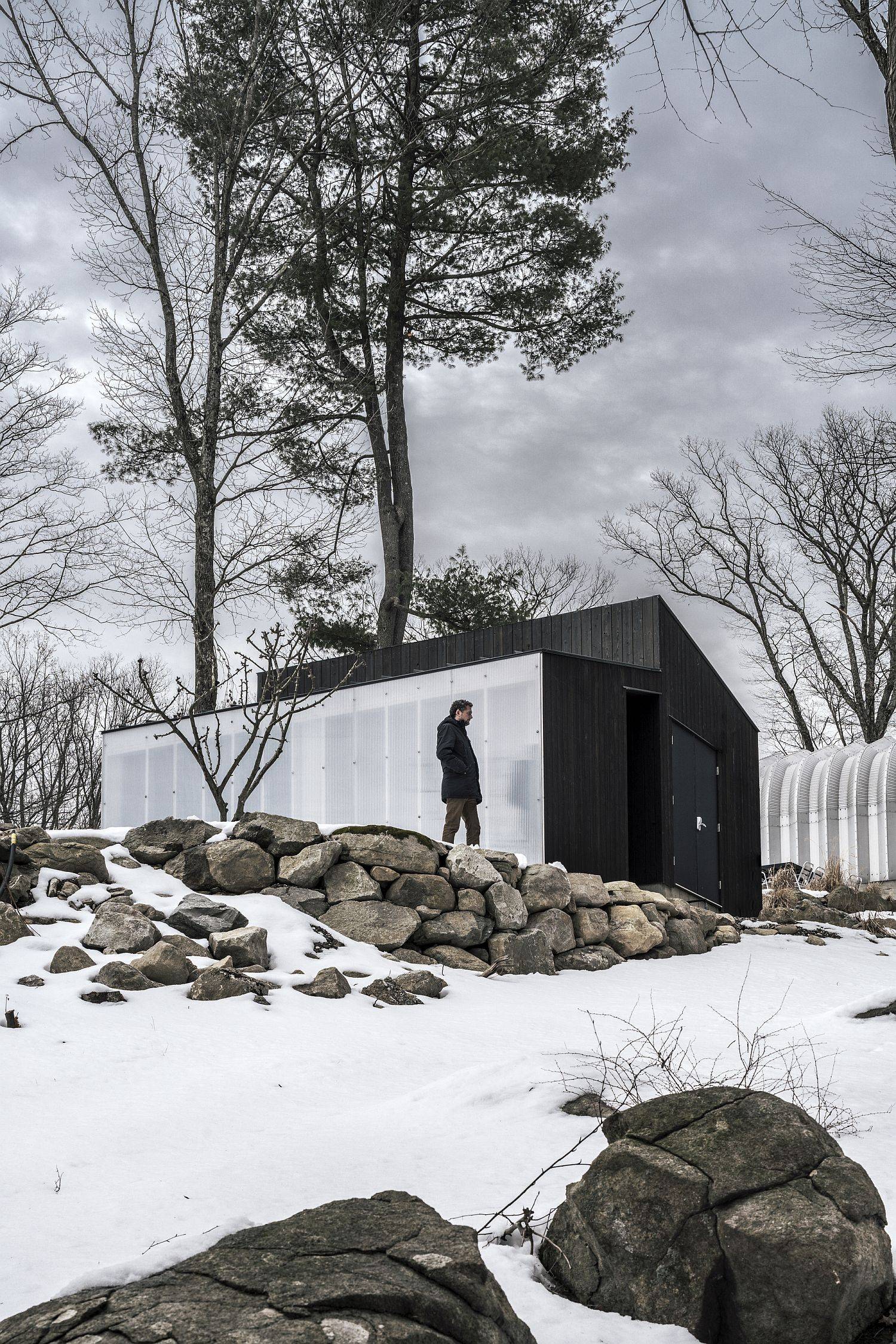 Polycarbonate panel wall brings a different aesthetic to this small wooden cabin in New York