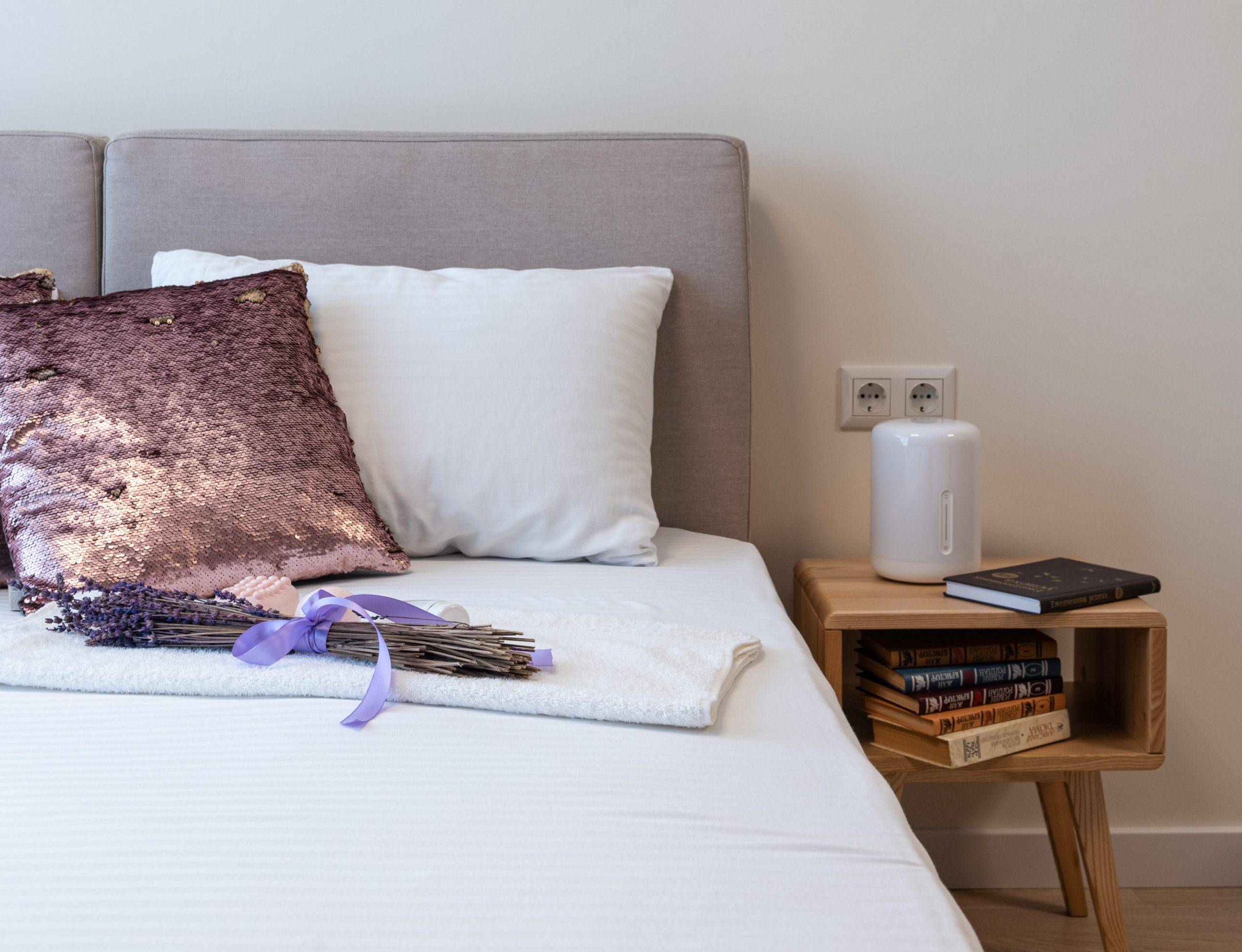 Purple cushion and lavender on bed