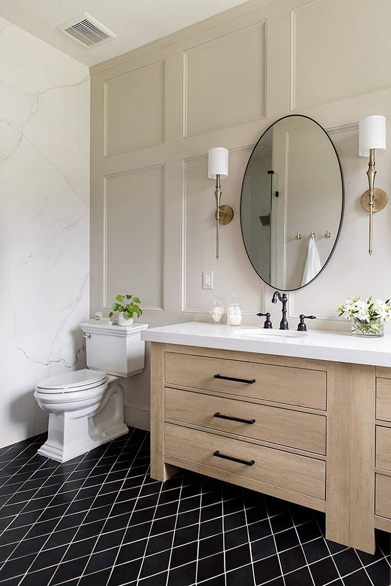 Round bathroom mirror in the middle of wall lamps