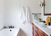 Rug-in-the-white-bathroom-complements-the-hue-of-the-wooden-vanity-in-here-95279-217x155