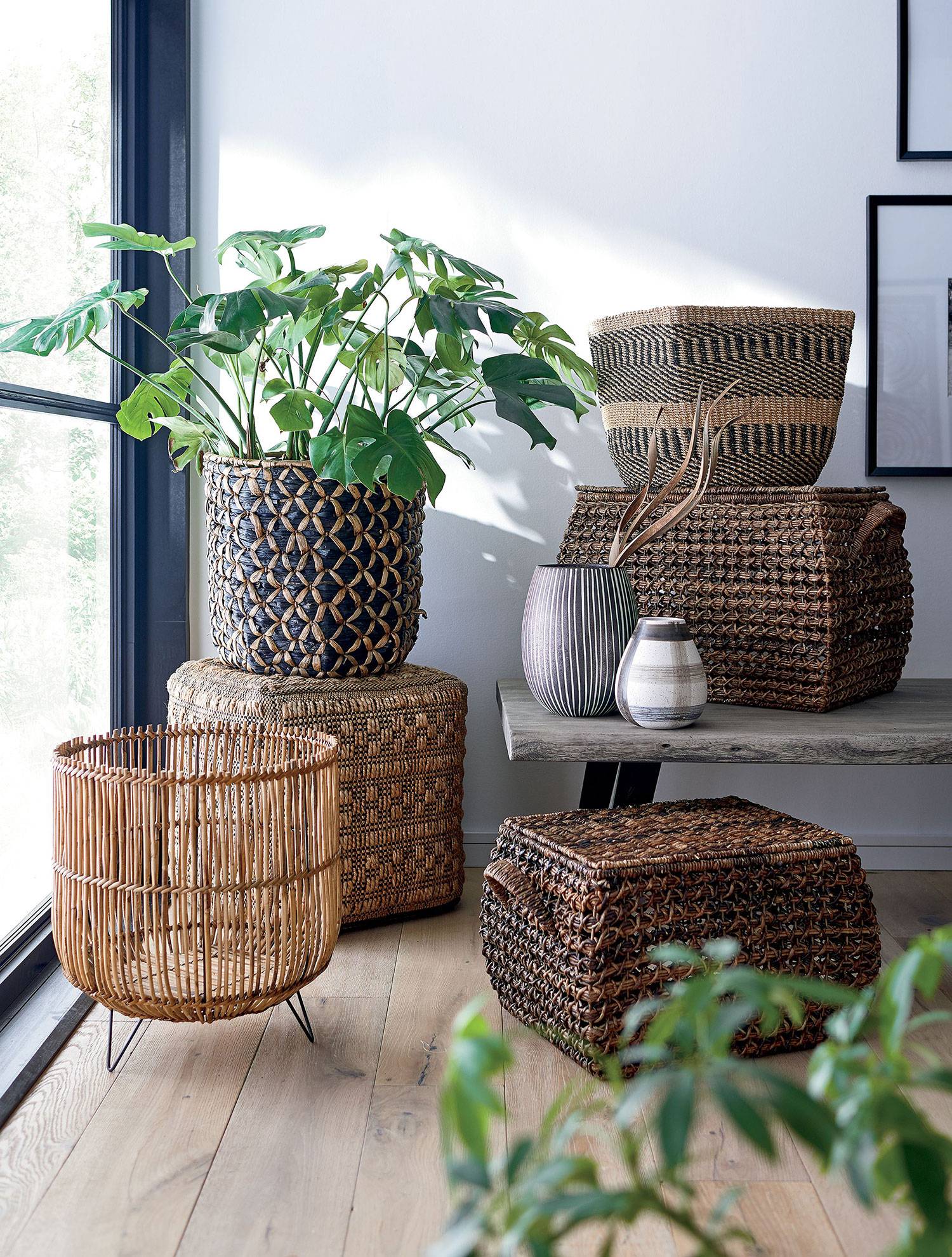 Stack of woven baskets with green plant