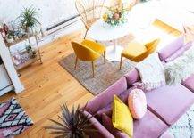 Top view of lavender sofa with cushions and coffee table with yellow chairs.v1
