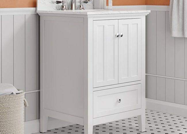 White bathroom vanity set beside hamper