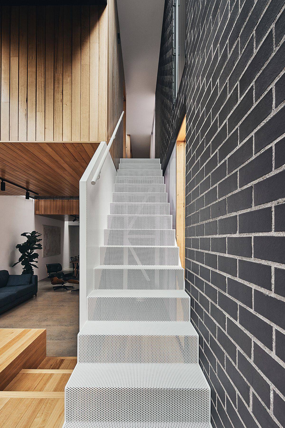 Wiry mesh-styled staircase leads to the top level of the home with bedrooms