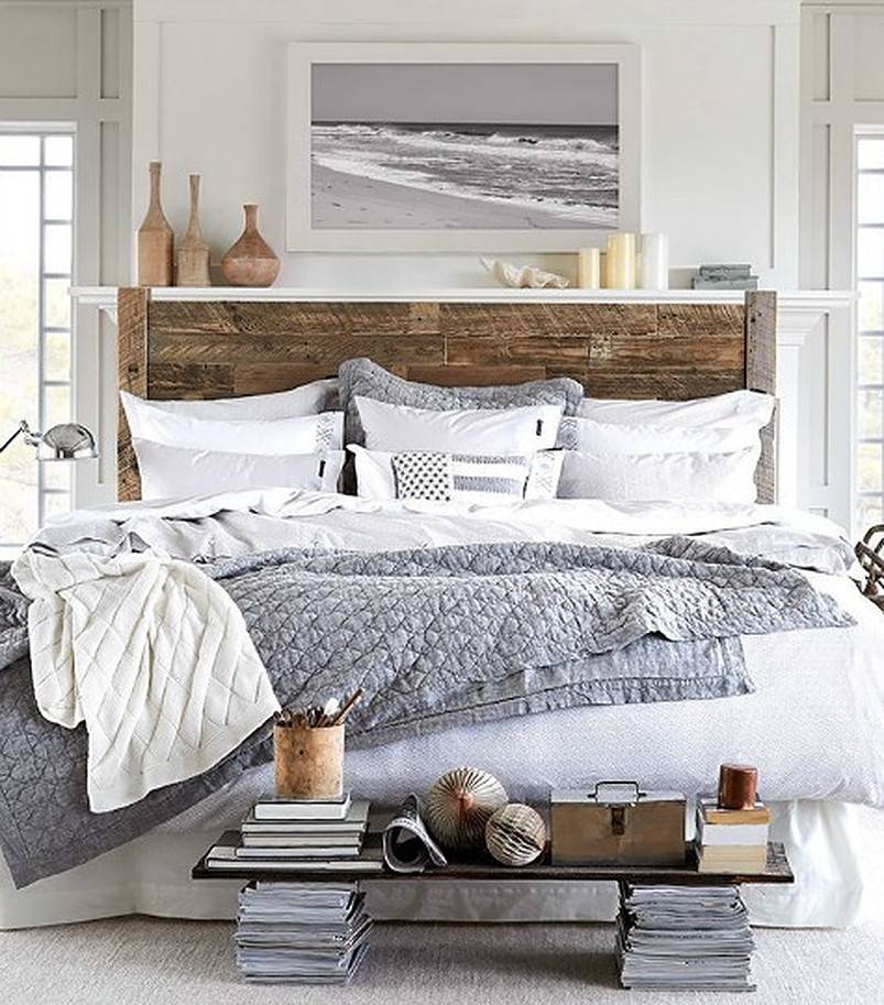 Wooden bed with grey and white sheets